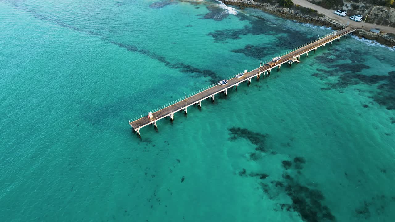 Drone aerial of Vivonne Bay jetty over clear turquoise water, Kangaroo Island, South Australia