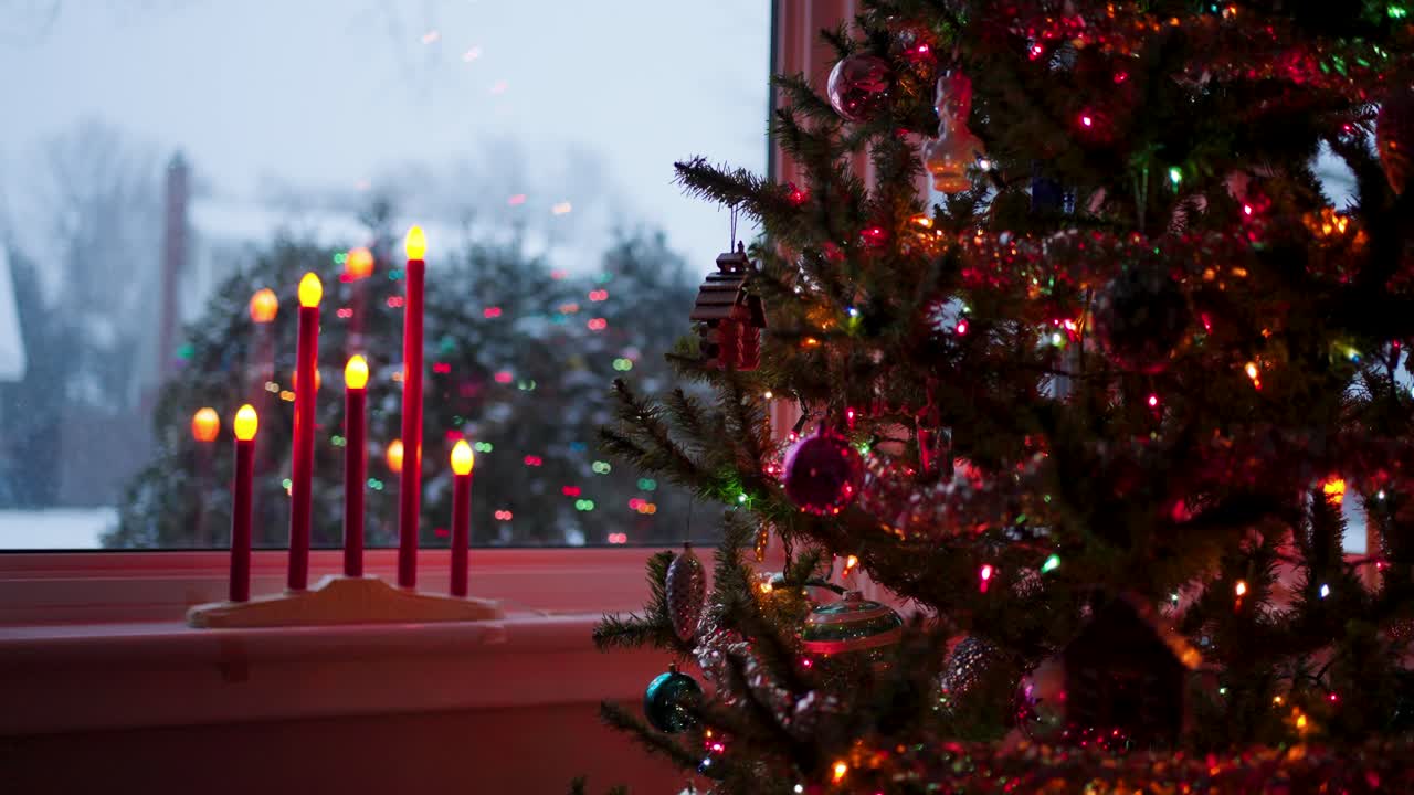 Snowy faux Christmas Tree and Candles on Christmas eve, shallow focus.