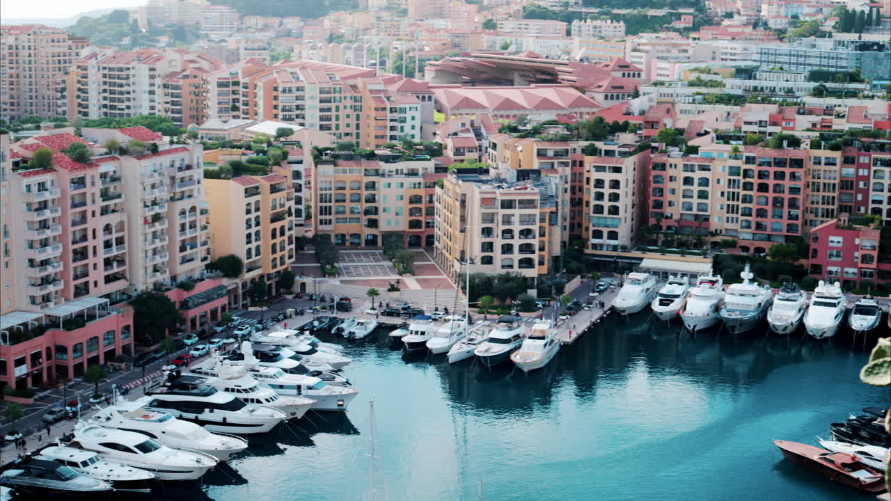 View of boats docked in the Port de Fontvieille with the skyline of Monaco on the background