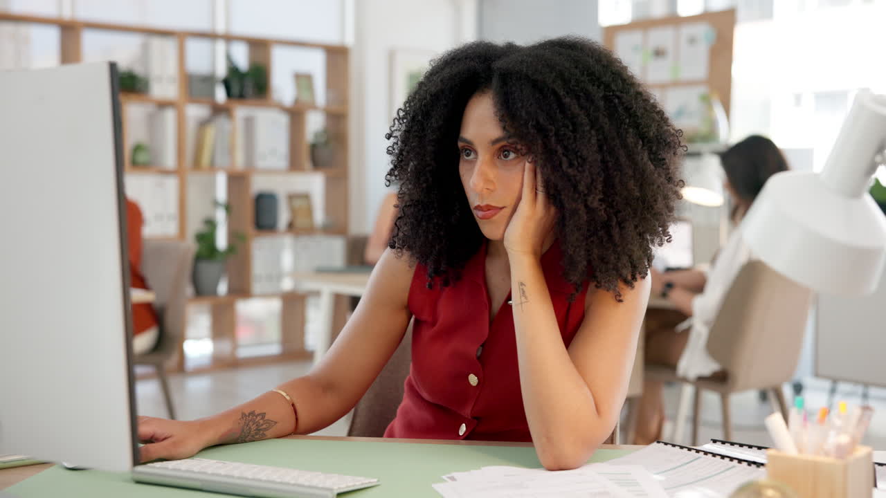 Focused Woman Working on Computer at Her Desk in a Modern Office