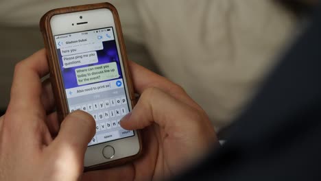 person using a smartphone to text message