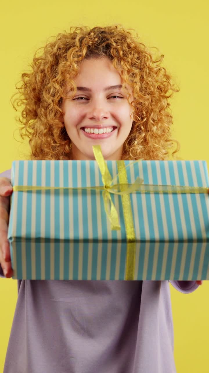 Happy young woman presenting a gift
