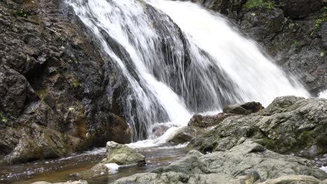 the picturesque waterfall that flows for eternity with a lot of stones around