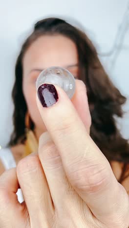 woman holding a clear crystal sphere