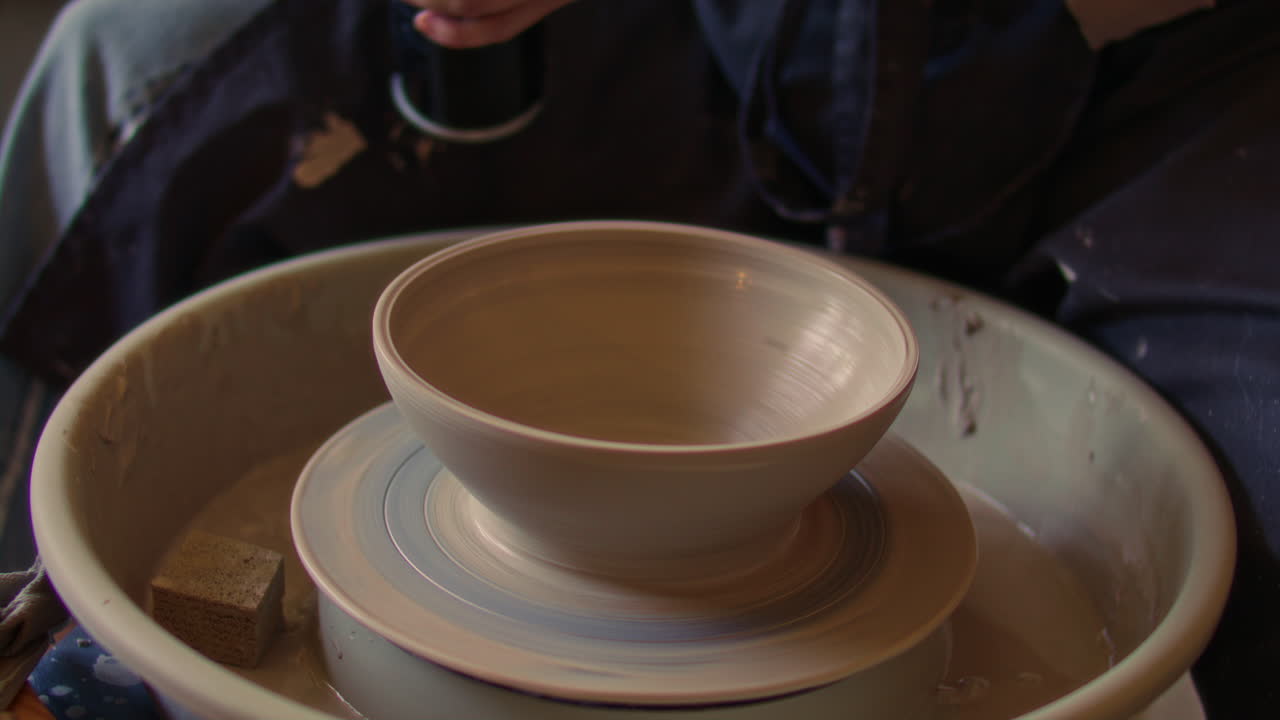 Close-Up of Drying Clay Bowl with Torch on Rotating Pottery Wheel