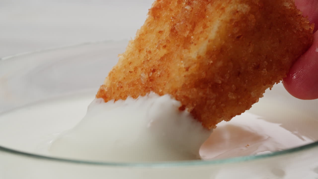 Fried food dipping in yogurt