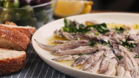 fresh sea sardines and anchovy fish and mullus on display on ice on market store shop. seafood fish background, close up stand of small salty white fish.