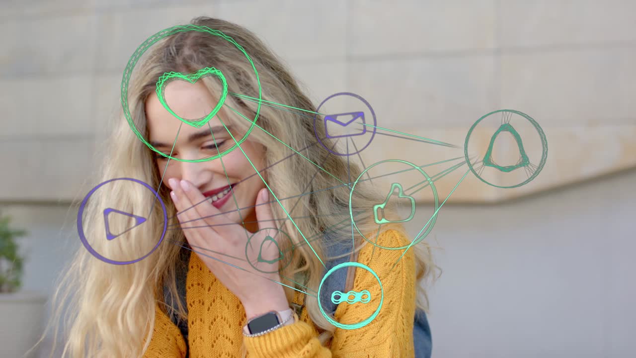 Woman sitting by wall with social media icons aligning with face, responding to alerts, smiling