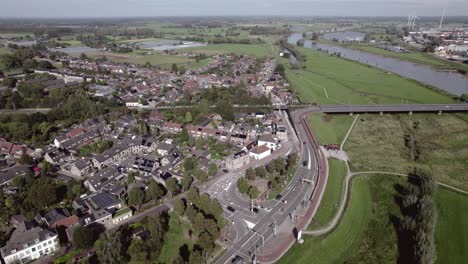 Aerial-reveal-of-wider-landscape-with-floodplains-next-to-residential-neighbourhood-De-Hoven-in-Zutphen,-The-Netherlands