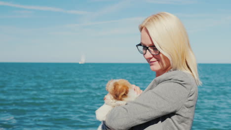 Woman-With-Puppy-by-the-Sea