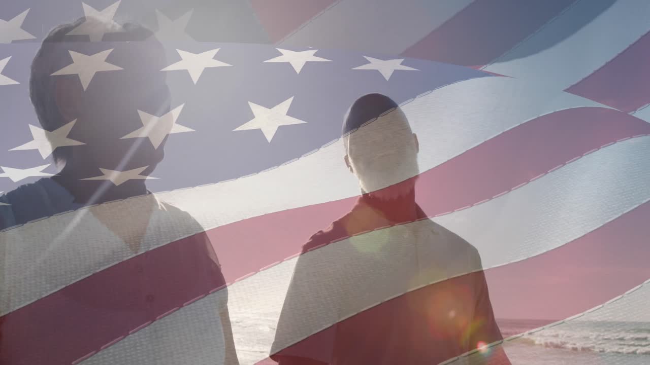 animación de la bandera de los ee.uu. sobre una feliz pareja biracial enamorada caminando por la playa