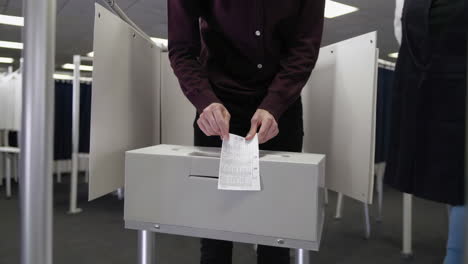 people casting votes at a polling place during an election