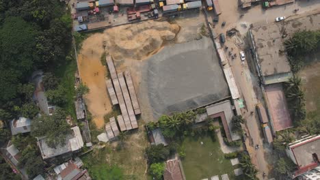 topdown view outdoor construction material warehouse, sand and stone storage, dhaka