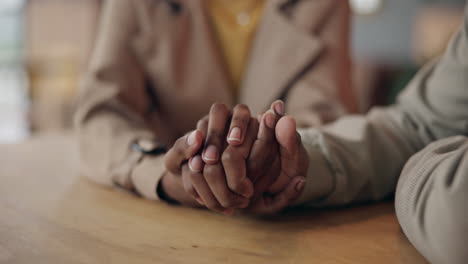 Holding-hands,-comfort-and-couple-at-table