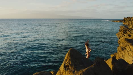 cliff jumping at sunset