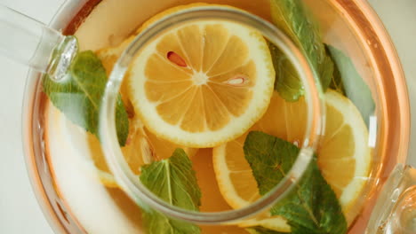 refreshing lemon and mint tea in a glass teapot