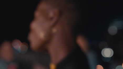 beautiful african american woman blow kissing camera friends drinking alcohol together making toast enjoying friendship reunion hanging out on rooftop party at night