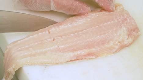 Close-up-of-Chef's-hands-cutting-fish-meat