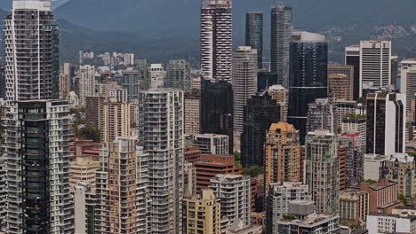 Vancouver-BC-Canada-Aerial-v120-zoomed-shot-drone-flyover-False-Creek-capturing-downtown-cityscape-and-West-End-residential-neighborhood-with-mountain-backdrop---Shot-with-Mavic-3-Pro-Cine---July-2023