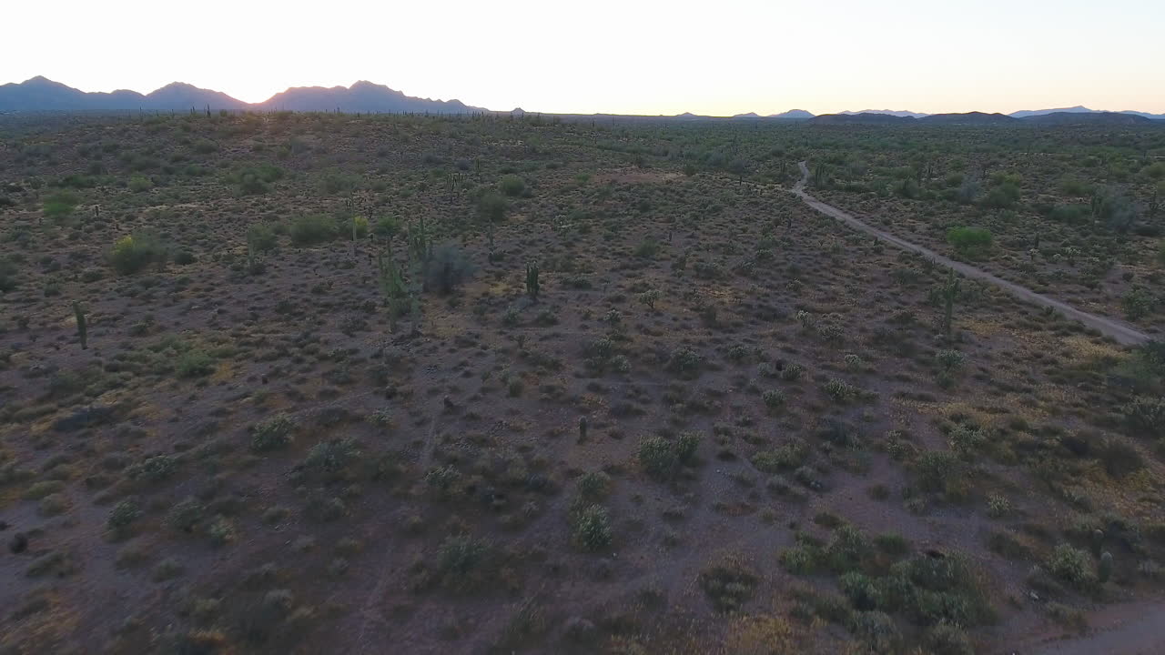seguimiento de la toma de un dron de la carretera que atraviesa un desierto vacío al atardecer ubicado cerca de flagstaff, arizona