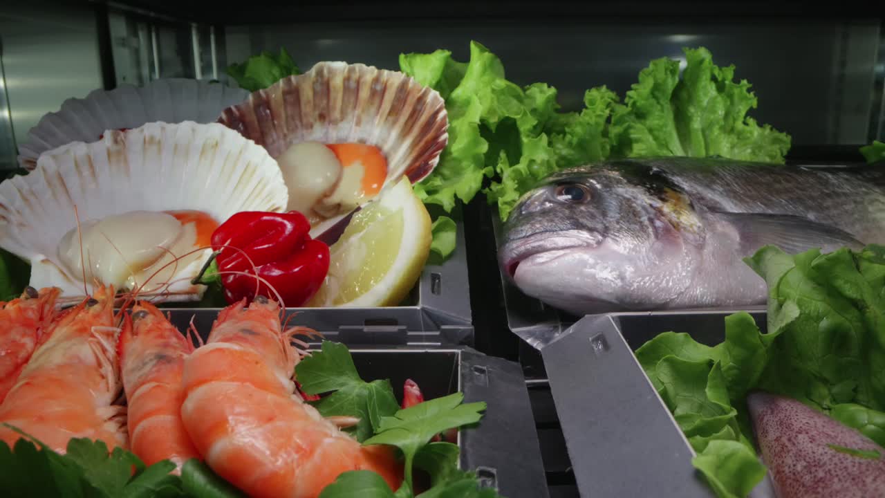 Refrigerated section showing fresh shellfish and raw fish with colorful garnish.