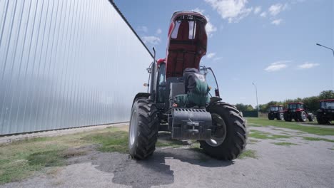 farmer mechanic repairing tractor. open tractor hood, engine. repair agricultural technology