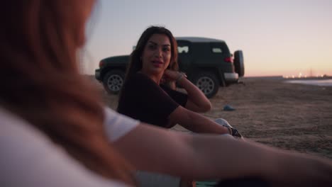 two friends enjoying a sunset on the beach