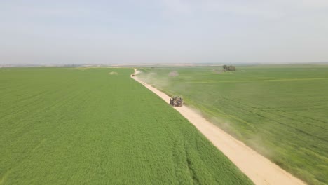 speeding idf military vehicles on golan heights between green fields