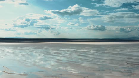 Aerial-view-of-salt-lake-with-beautiful,-cloudy,-blue-sky