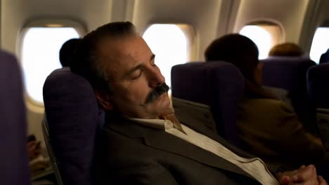 man sleeping on airplane