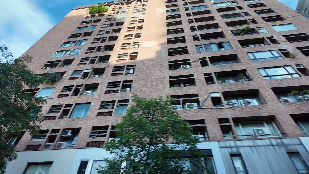 Driving through the city while looking at the urban scenery from the passenger seat