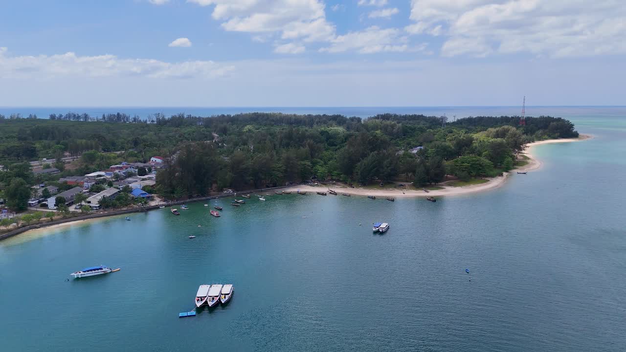 Drone footage captures a serene aerial view of Sarasin Bridge in Phuket, Thailand, with turquoise waters and lush greenery