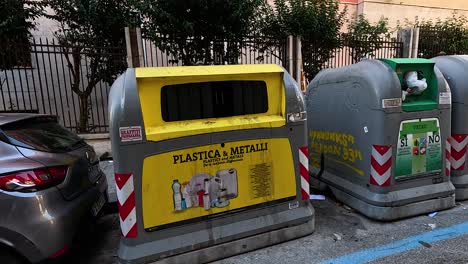 garbage bins and parked car in naples, italy