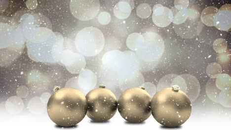 animation of snow falling over christmas baubles