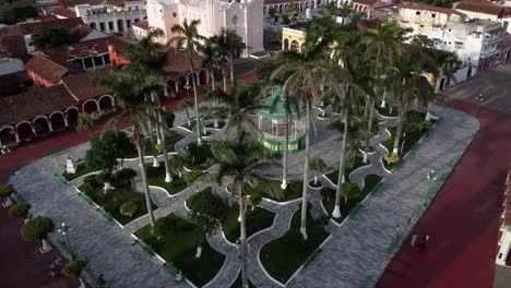 tilt down drone shot of downtown tlacotalpan with people walking, veracruz