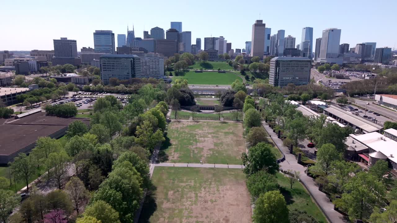 Flying over Bicentennial Capitol Mall State Park with a view of the Nashville, Tennessee city skyline at daytime