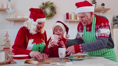 grandfather with cups hot chocolate walking on christmas home kitchen to grandmother and grandchild