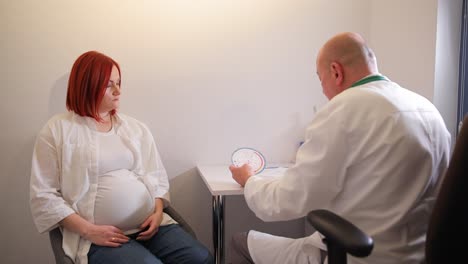 pregnant woman consulting with doctor