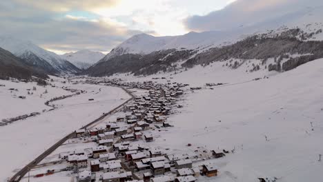 Stunning-Livigno-Alps-drone-video:-snow-peaks,-city-and-mountain-town,-ideal-for-high-quality-winter-and-tourism-ads