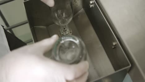 male worker filling bottles with liquor 4k