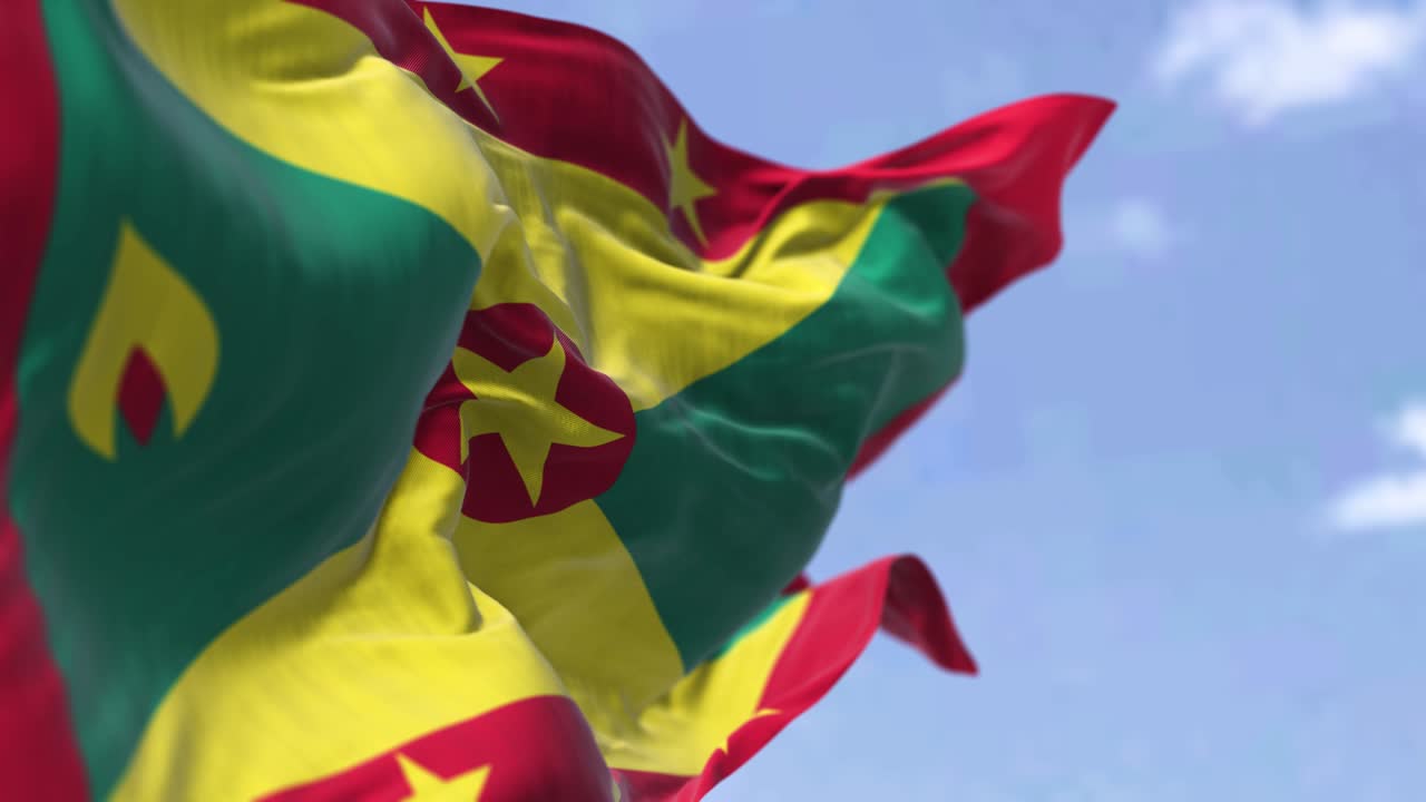 detalle de la bandera nacional de granada ondeando en el viento en un día despejado