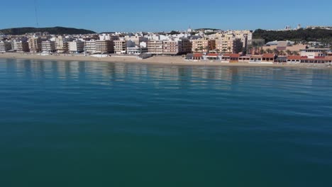 Aerial-approach-to-the-coastal-town-of-Guardamar-del-Segura,-spanish-Mediterranean