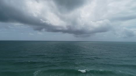 aerial view footage of rain clouds over sea ocean black clouds in bad weather day over sea surface high angle view