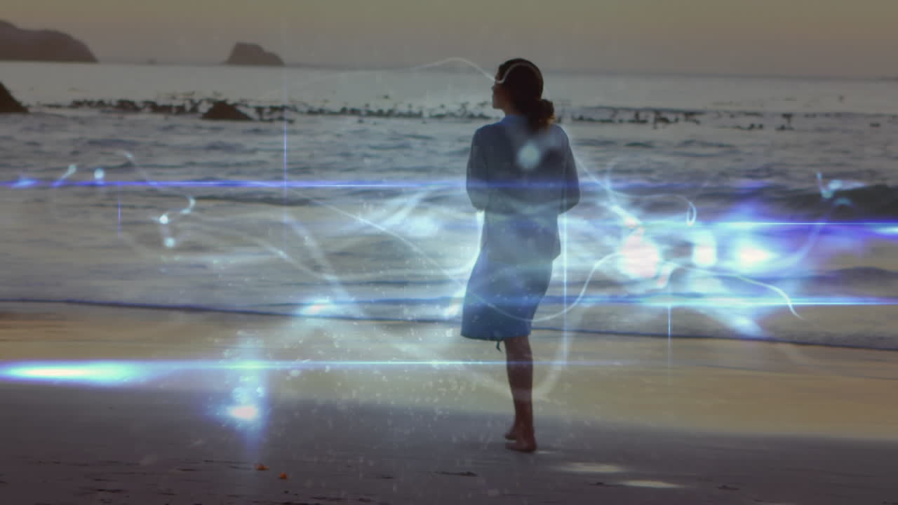 animación de rastros de luz sobre una mujer caucásica caminando por la playa