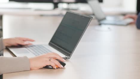 office workers typing on laptops