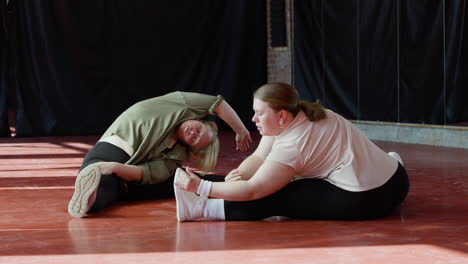 Women-stretching-indoors