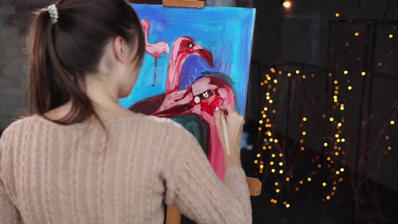 Woman Painting Flamingos on Canvas