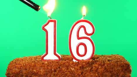 cake with the number 16 lighted candle. chroma key. green screen. isolated