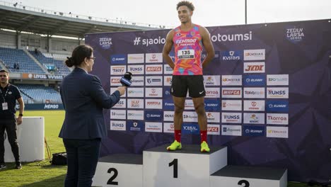 athlete receiving medal in award ceremony: a moment of triumph and celebration on the podium after a competitive event, highlighting athletic achievements and recognition