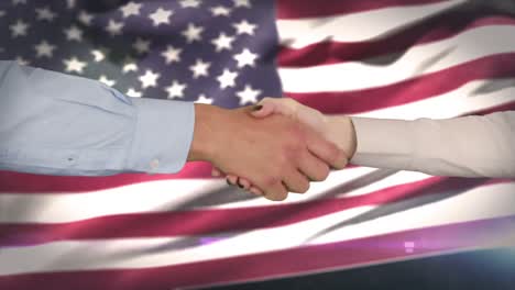 hands shaking against american flag